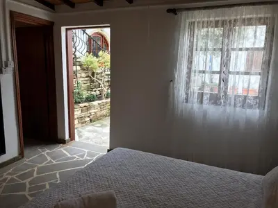 a bedroom with a bed and a window at Cobblers in Maroni