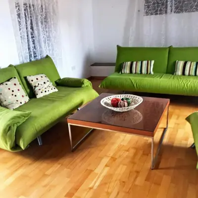 a living room with green couches and a coffee table at Cobblers in Maroni