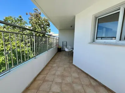 a balcony with a window and a table and chair at Cozy Stay Nicosia in Nicosia