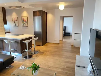 a room with a kitchen and a living room with a table at Limassol Marina Seaview Suite in Limassol