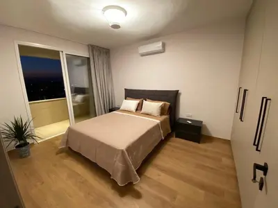 a bedroom with a bed and a large window at Limassol Marina Seaview Suite in Limassol