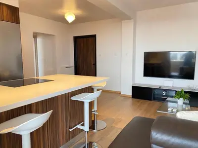 a living room with a bar and a tv at Limassol Marina Seaview Suite in Limassol