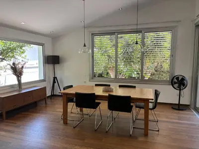 a dining room with a wooden table and chairs at 3 Bedroom Oceanfront Oasis for Memorable Vacations in Voroklini