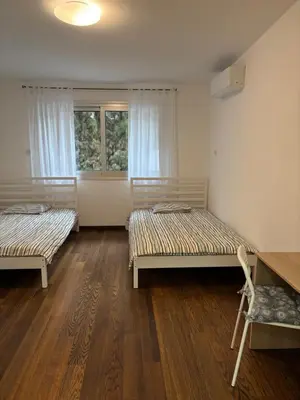 a room with two beds and a window at 3 Bedroom Oceanfront Oasis for Memorable Vacations in Voroklini