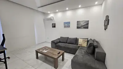 a living room with a couch and a coffee table at STAY Finibreeze Apartment in Larnaka
