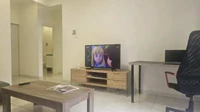 a living room with a flat screen tv and a table at STAY Finibreeze Apartment in Larnaka