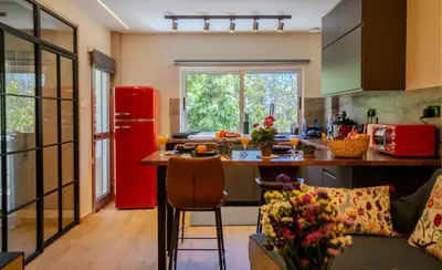 a kitchen with a red refrigerator and a table at 1 BDR New Boutique & Prime Location in Limassol