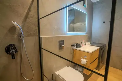 a bathroom with a shower and a toilet and a sink at 1 BDR New Boutique & Prime Location in Limassol