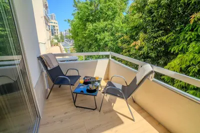 a balcony with two chairs and a table on a balcony at 1 BDR New Boutique & Prime Location in Limassol