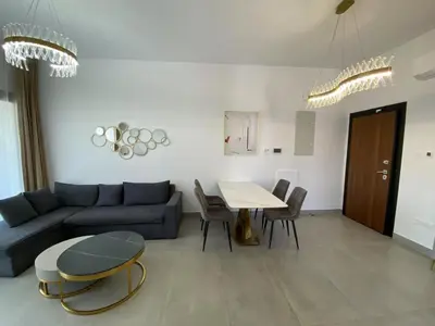 a living room with a blue couch and a table at 1 bedroom 104 in Limassol
