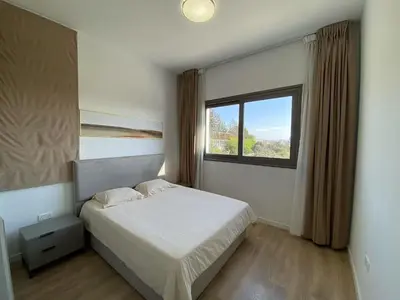 a bedroom with a white bed and a window at 1 bedroom 104 in Limassol