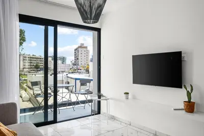 a living room with a flat screen tv on a wall at Majan Residences in Larnaka