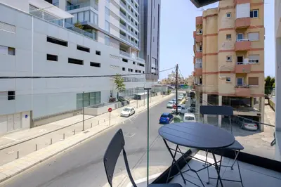 a table on a balcony with a view of a street at Majan Residences in Larnaka