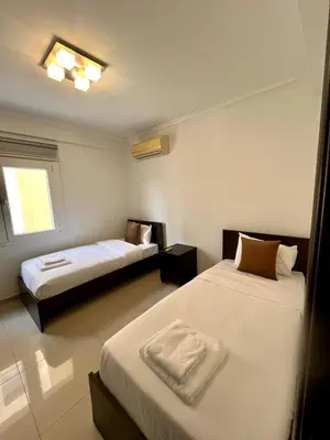 a hotel room with two beds and a window at Sunny Stay 2 Bdr near the sea Platform 357 in Limassol