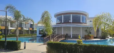 a building with a swimming pool and a house at Modern Luxury Apartment in Aglantzia
