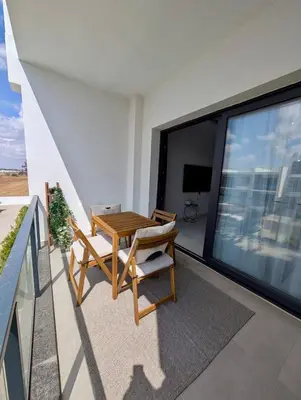 a balcony with a table and chairs on a building at Modern Luxury Apartment in Aglantzia