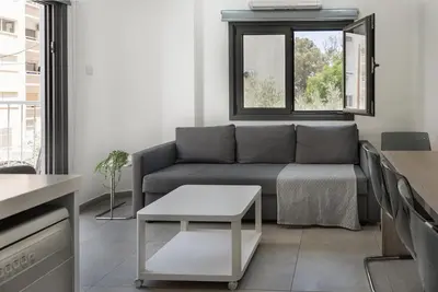 a living room with a couch and a window at Seabreeze Residence by Staycom in Larnaka
