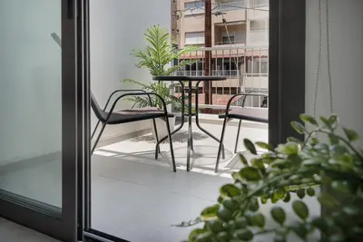 a patio with a table and chairs on a balcony at Seabreeze Residence by Staycom in Larnaka