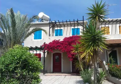 a house with pink flowers in front of it at L'Azure 24 - Protaras in Paralimni