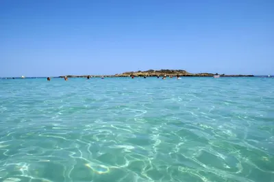 a group of people swimming in the ocean at L'Azure 24 - Protaras in Paralimni