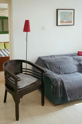 a bedroom with a bed and a chair and a lamp at Mediterraneo 27 - Protaras in Protaras