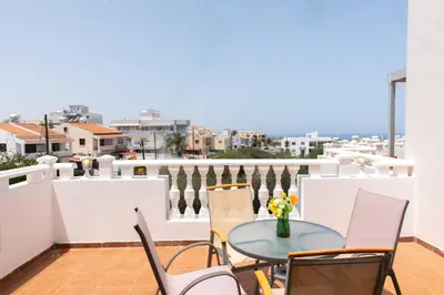 a balcony with a table and chairs and a view at STAY Kali Sun Apartment in Paralimni