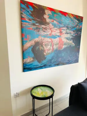 a painting of a person swimming in the water at Serene Getaway Near Protaras in Paralimni