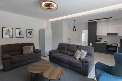 a living room with two couches and a table at Kakopetria Luxury Villa w pool in Kakopetria