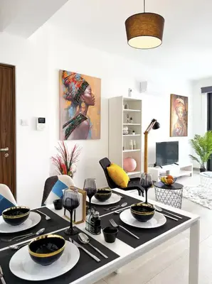 a dining room with a table with dishes on it at Sunset Balcony and Espresso Station Apartment in Larnaka