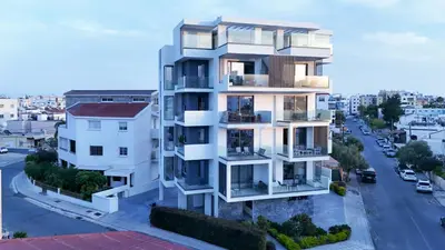 an apartment building with balconies and a street at Sunset Balcony and Espresso Station Apartment in Larnaka