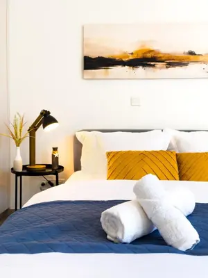 a bedroom with a bed with towels on it at Sunset Balcony and Espresso Station Apartment in Larnaka