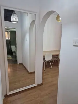 a hallway with a mirror and a table in a room at Cosy 2-Bedroom Apartment, 10 Minutes from the Beach in Larnaka