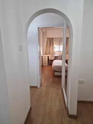 a hallway with an archway leading to a bedroom at Cosy 2-Bedroom Apartment, 10 Minutes from the Beach in Larnaka
