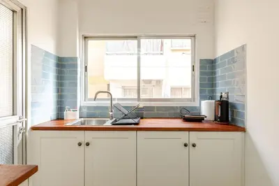 a kitchen with a sink and a window at Cosy 2-Bedroom Apartment, 10 Minutes from the Beach in Larnaka