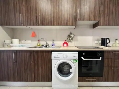 a kitchen with a washing machine and a sink at Albert's Apartment Center 203B in Larnaka