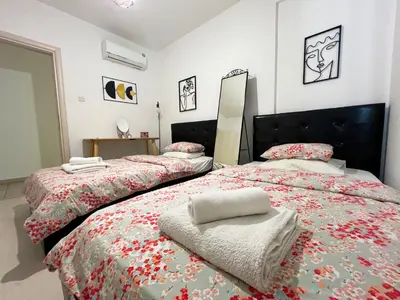 two beds sitting next to each other in a bedroom at Albert's Apartment Center 203B in Larnaka