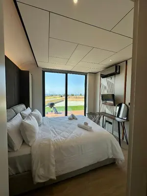 a bedroom with a large bed with a large window at Infinity Residences in Zygi