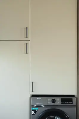 a kitchen with a washing machine and a cabinet at Infinity Residences in Zygi