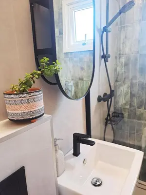 a bathroom with a sink and a mirror at Sea View Floral Suite - 2 bedroom in Larnaka