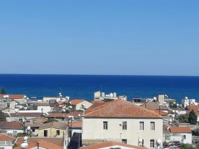 a view of a town with the ocean in the background at Sea View Floral Suite - 2 bedroom in Larnaka