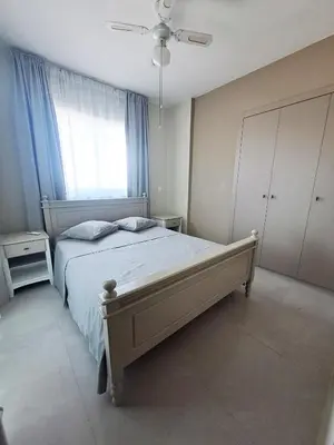 a bedroom with a large bed and a window at Sea View Floral Suite - 2 bedroom in Larnaka
