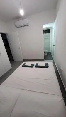 a large white room with two mattresses on a bed at Hanapartment 3 bed Ayia NAPA in Ayia Napa