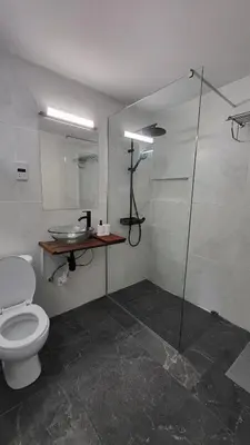a bathroom with a toilet and a glass shower at Hanapartment 3 bed Ayia NAPA in Ayia Napa