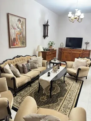 a living room with couches and a tv at 2 bedroom apartment 50 meters from the sea in Limassol