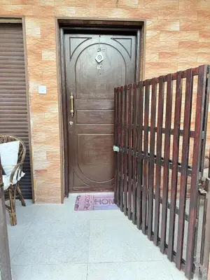 a brown door of a house with a fence at 2 bedroom apartment 50 meters from the sea in Limassol