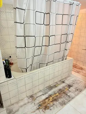 a shower in a bathroom with white tiles at 2 bedroom apartment 50 meters from the sea in Limassol