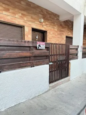 a sign on a fence in front of a house at 2 bedroom apartment 50 meters from the sea in Limassol