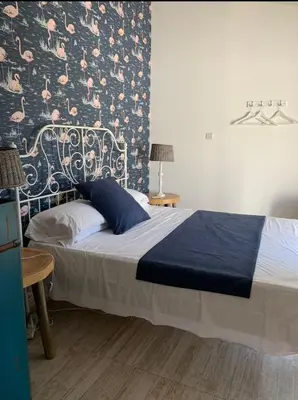 a bedroom with a bed with a patterned wall at Elysian Villa in Larnaka