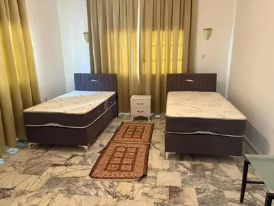two beds sitting in a room with a tiled floor at Heritage Villas Northern Cyprus in Mağusa