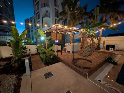 a wooden deck with a metal object with lights at Heritage Villas Northern Cyprus in Mağusa